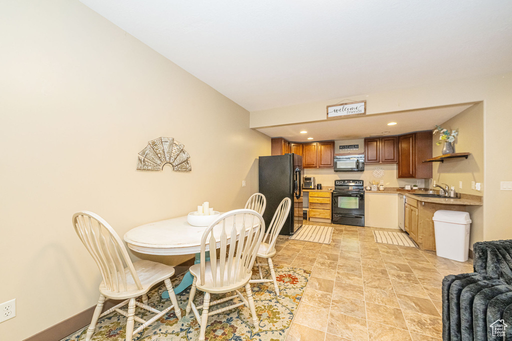 Dining room featuring light stone finish floors and recessed lighting
