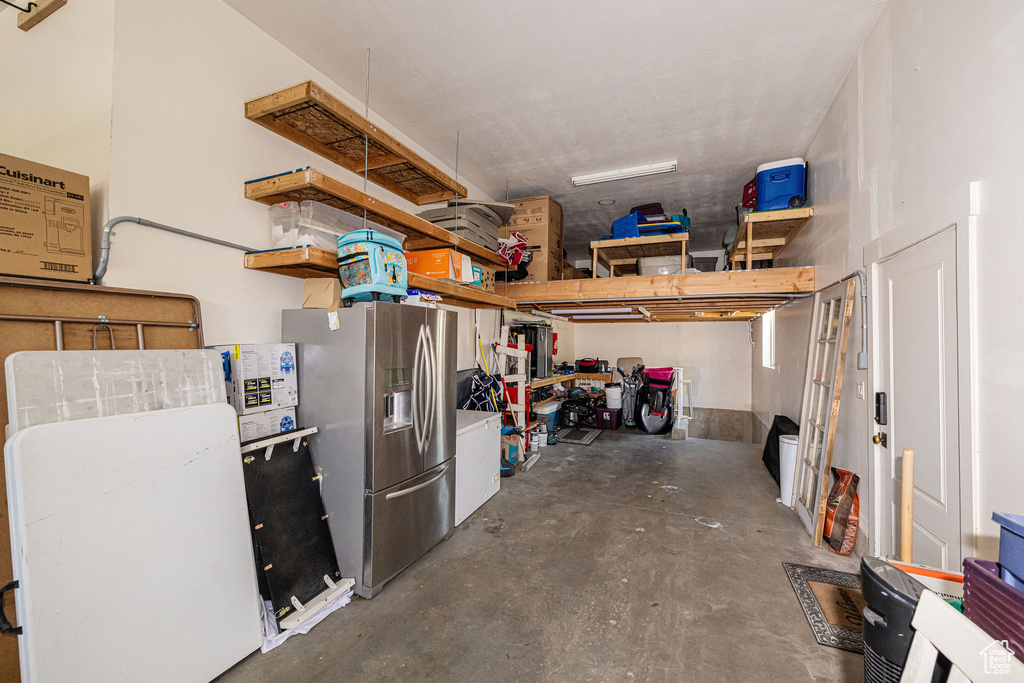 Garage featuring stainless steel fridge with ice dispenser