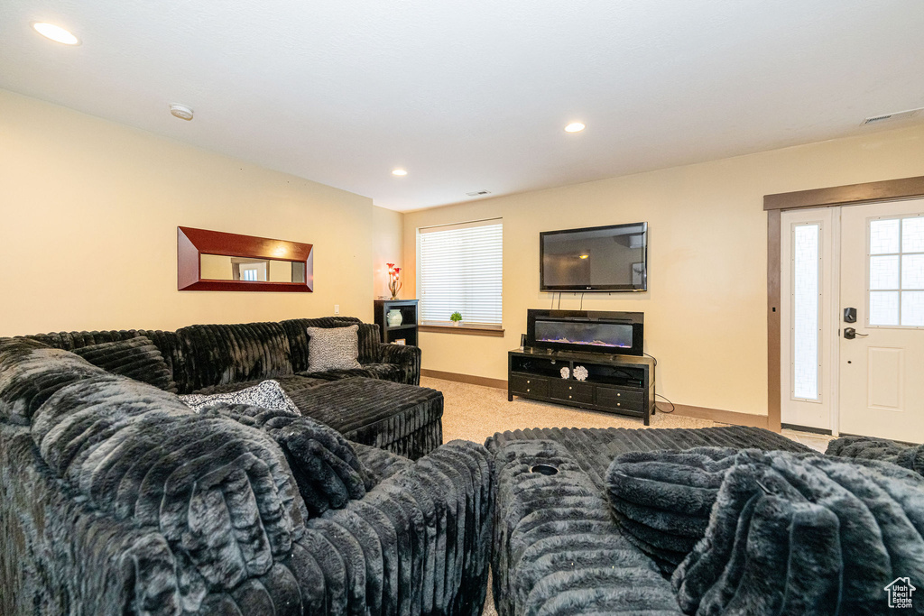 Carpeted living room featuring baseboards and recessed lighting