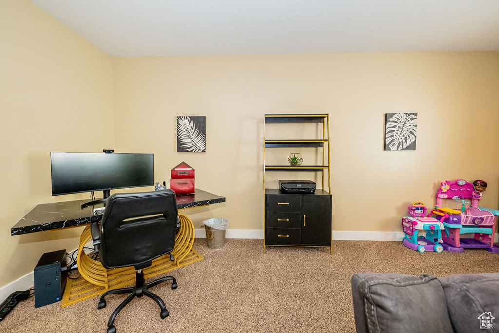 Office area featuring baseboards and carpet flooring