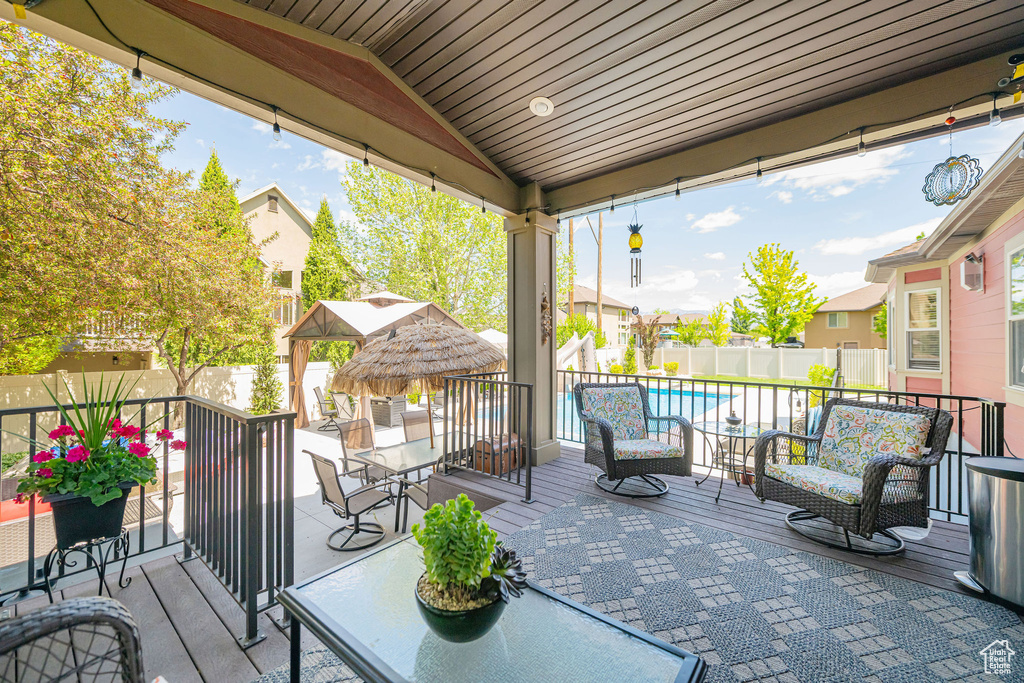 View of patio with a fenced backyard, a wooden deck, and outdoor lounge area