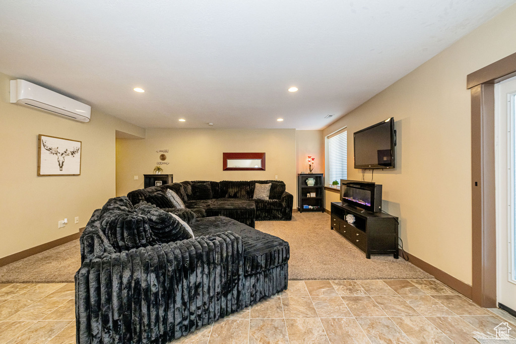 Living room featuring a wall unit AC, light carpet, recessed lighting, and baseboards