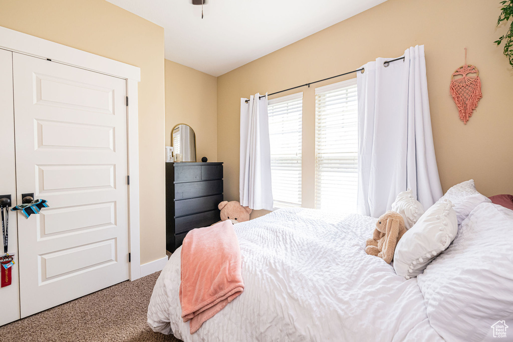 Carpeted bedroom with baseboards