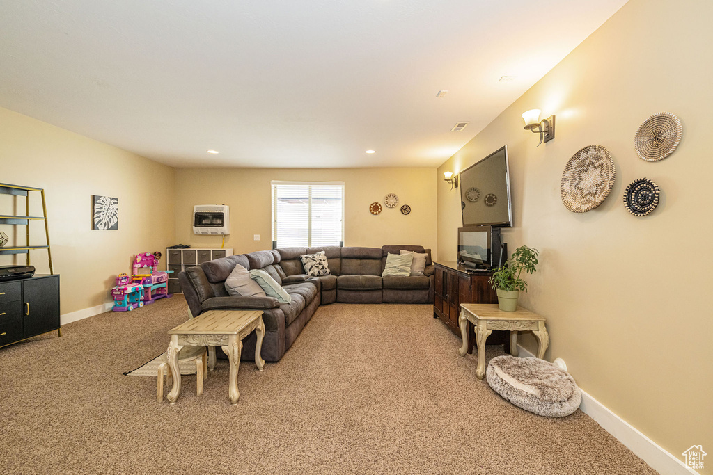 Living area featuring light carpet and baseboards