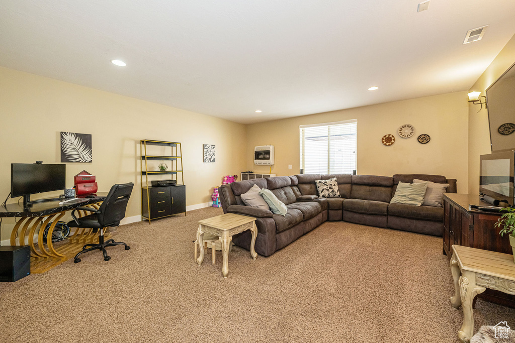 Living area with light carpet, a desk, recessed lighting, and baseboards