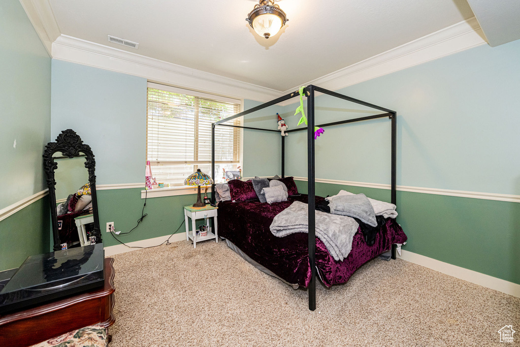 Bedroom featuring ornamental molding, carpet floors, and baseboards