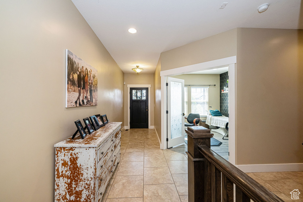 Entrance foyer with baseboards, light tile patterned floors, and recessed lighting