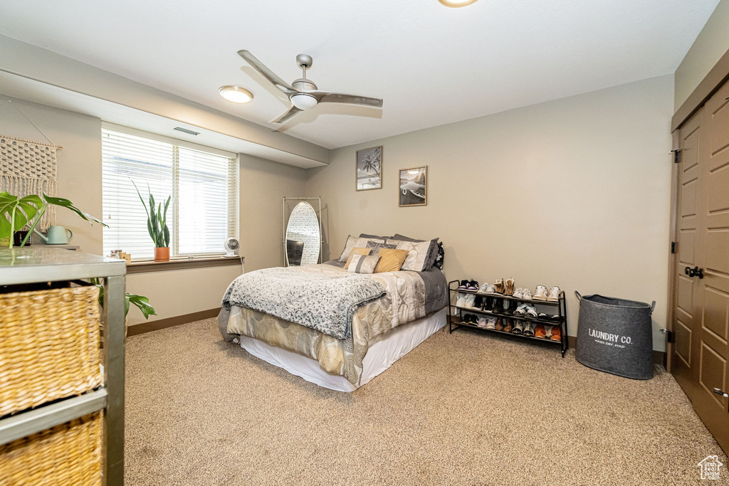 Bedroom featuring carpet floors, baseboards, and ceiling fan