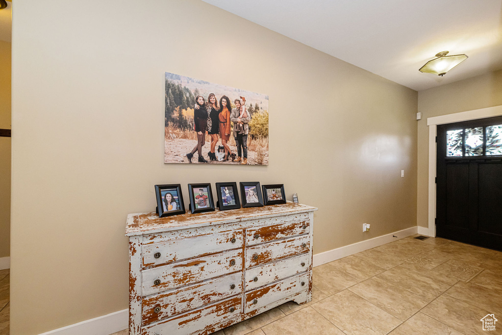 Entrance foyer featuring baseboards and light tile patterned floors