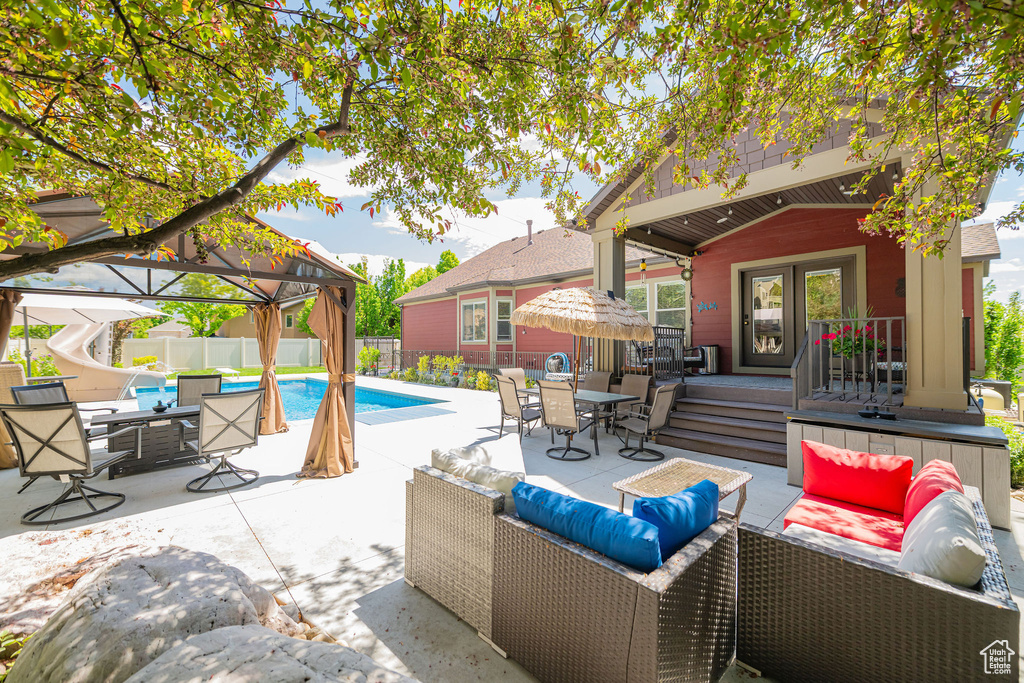 View of patio / terrace with an outdoor hangout area, a gazebo, fence, and outdoor dining space