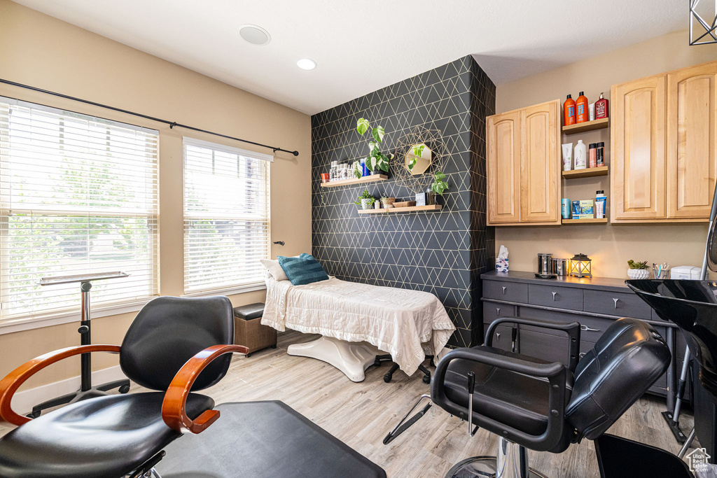 Bedroom featuring wood finished floors, tile walls, and recessed lighting