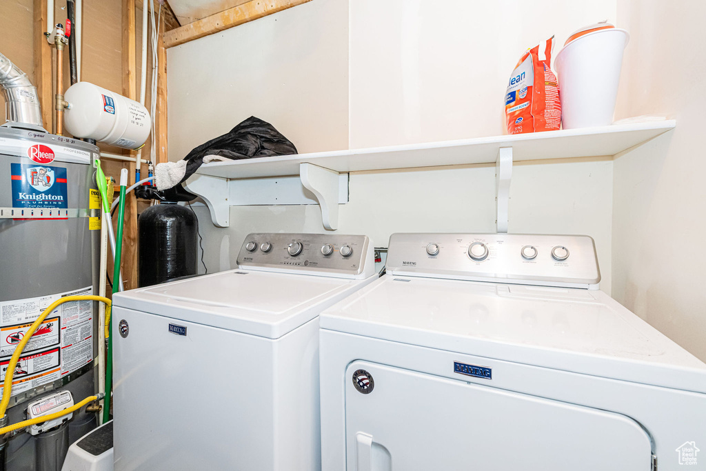 Laundry area with water heater and washing machine and dryer