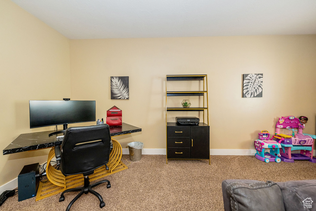 Office area featuring carpet floors and baseboards