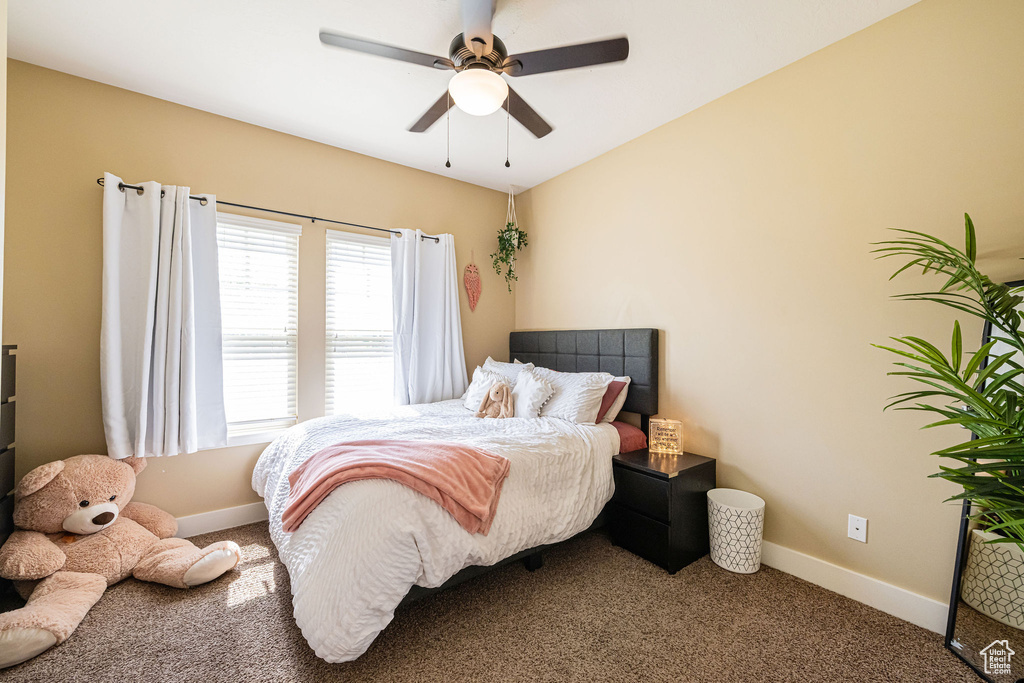 Bedroom featuring carpet floors, baseboards, and a ceiling fan