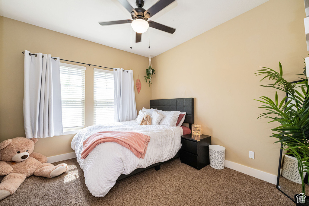 Bedroom with carpet flooring, baseboards, and ceiling fan