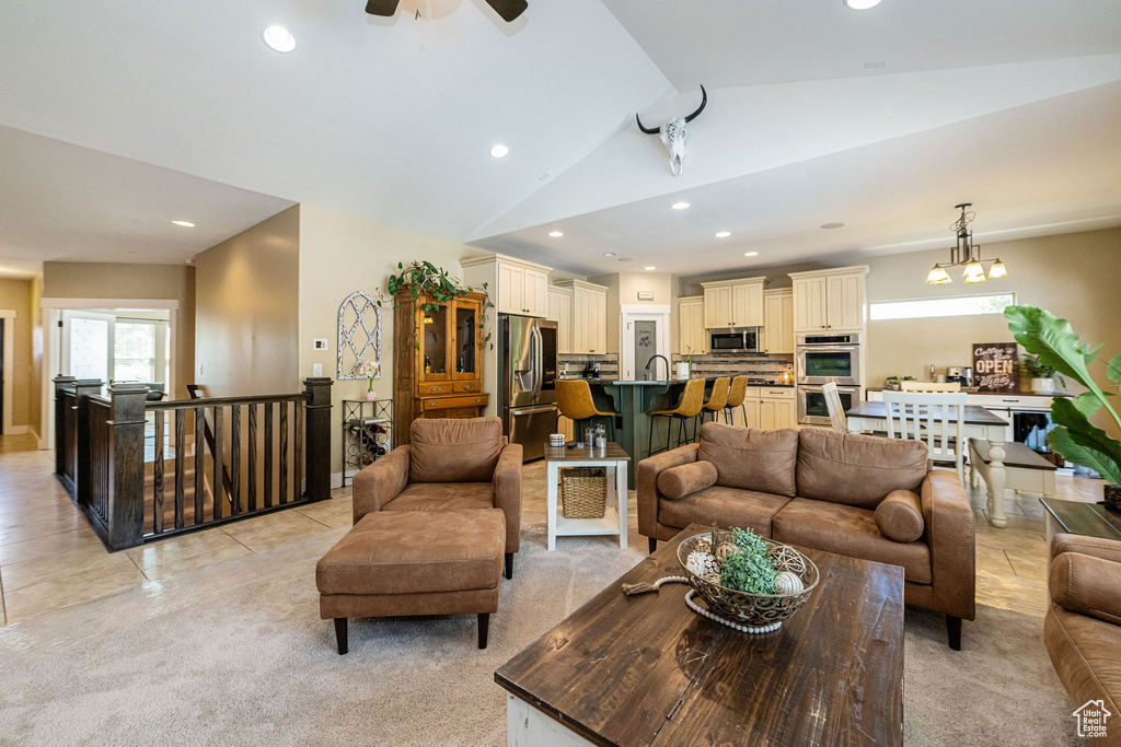 Living area with recessed lighting, lofted ceiling, a ceiling fan, and light tile patterned flooring