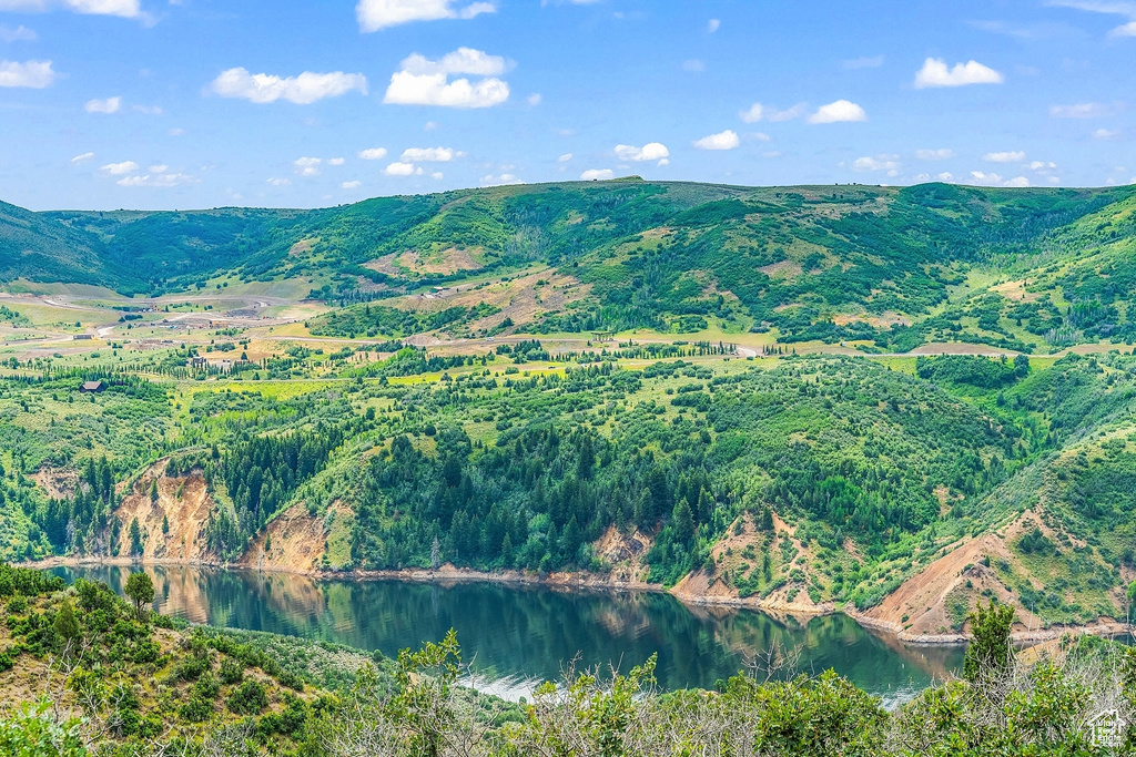 View of mountain backdrop featuring a nearby body of water