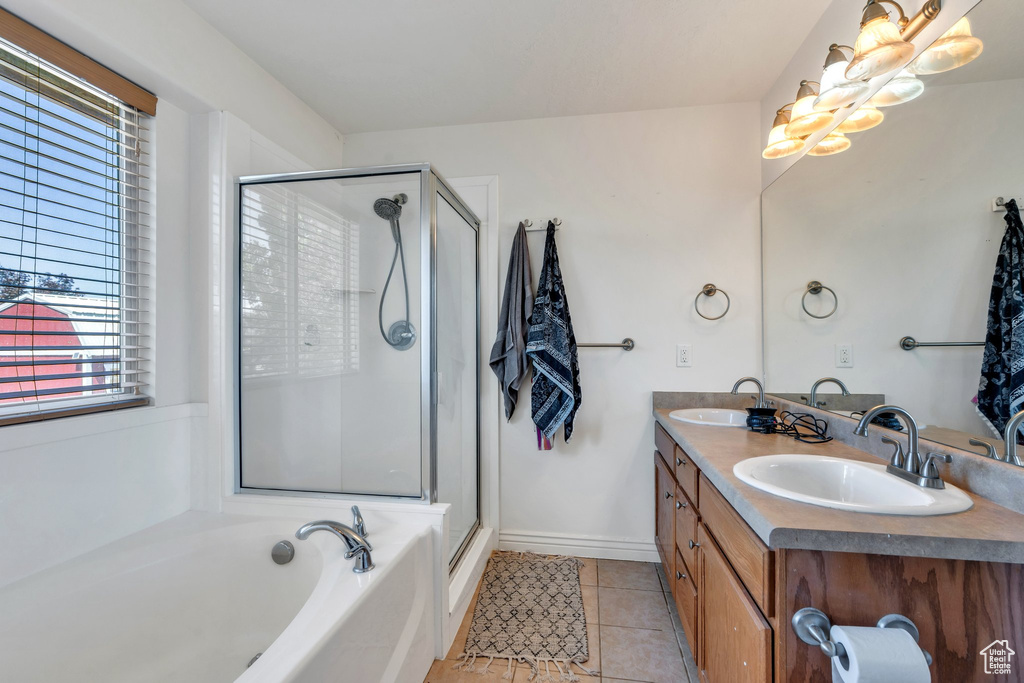Full bath featuring tile patterned floors, a shower stall, a bath, and double vanity
