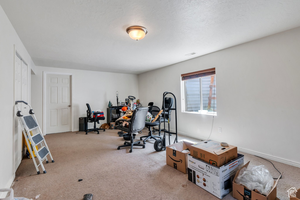 Exercise area featuring carpet flooring and baseboards