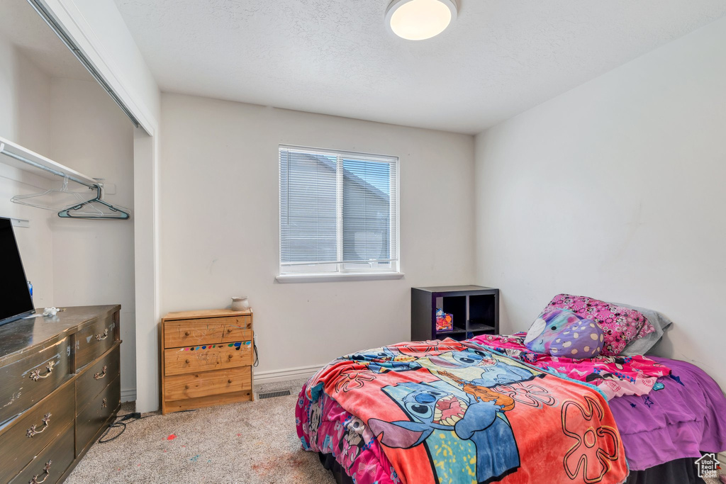 Bedroom with carpet flooring and baseboards