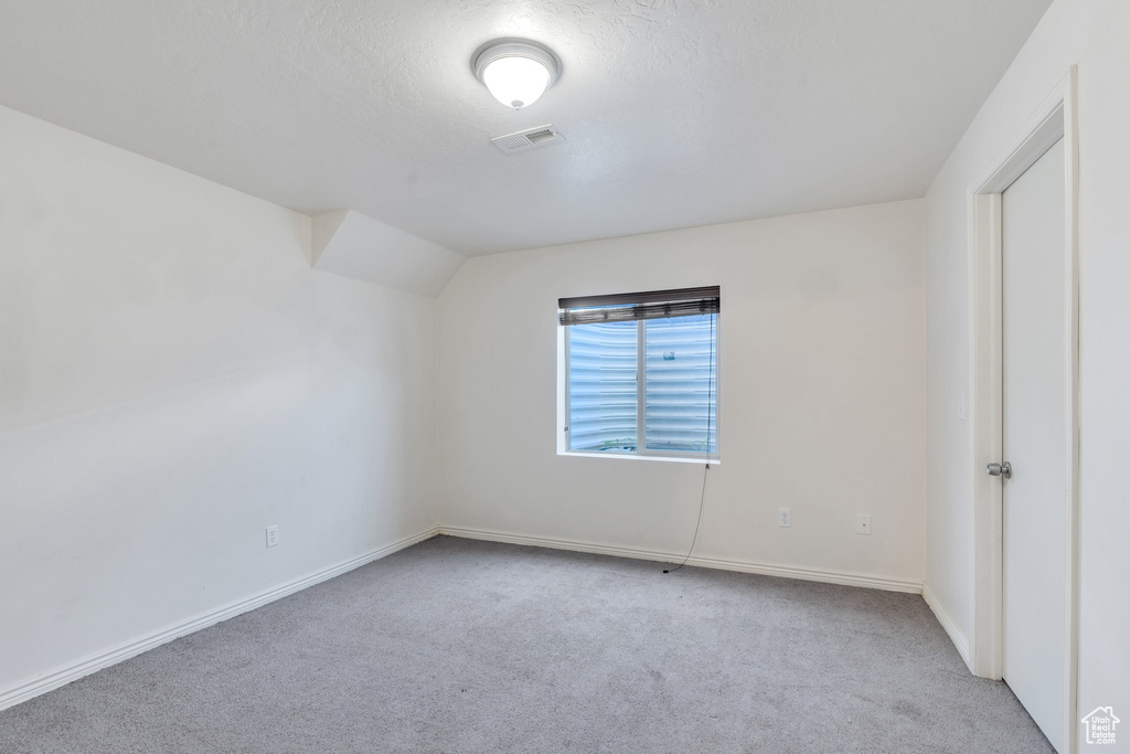 Carpeted empty room with baseboards