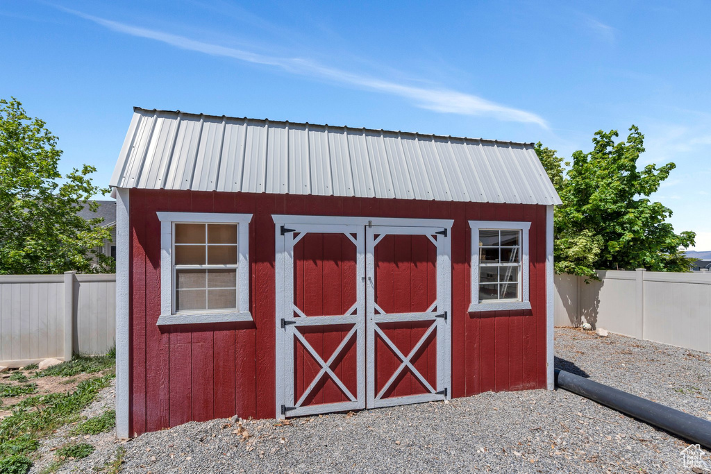 View of shed with a fenced backyard