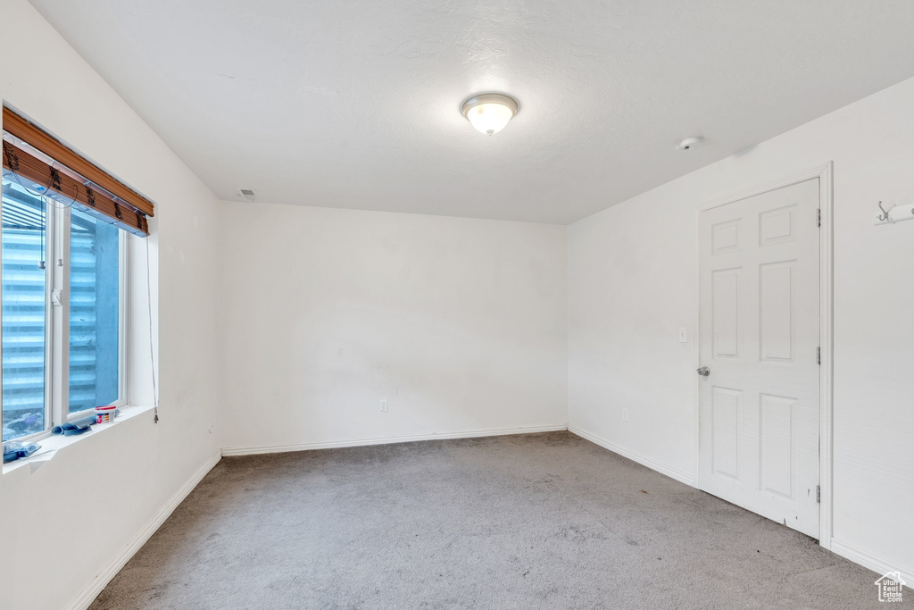 Unfurnished room with carpet flooring and baseboards