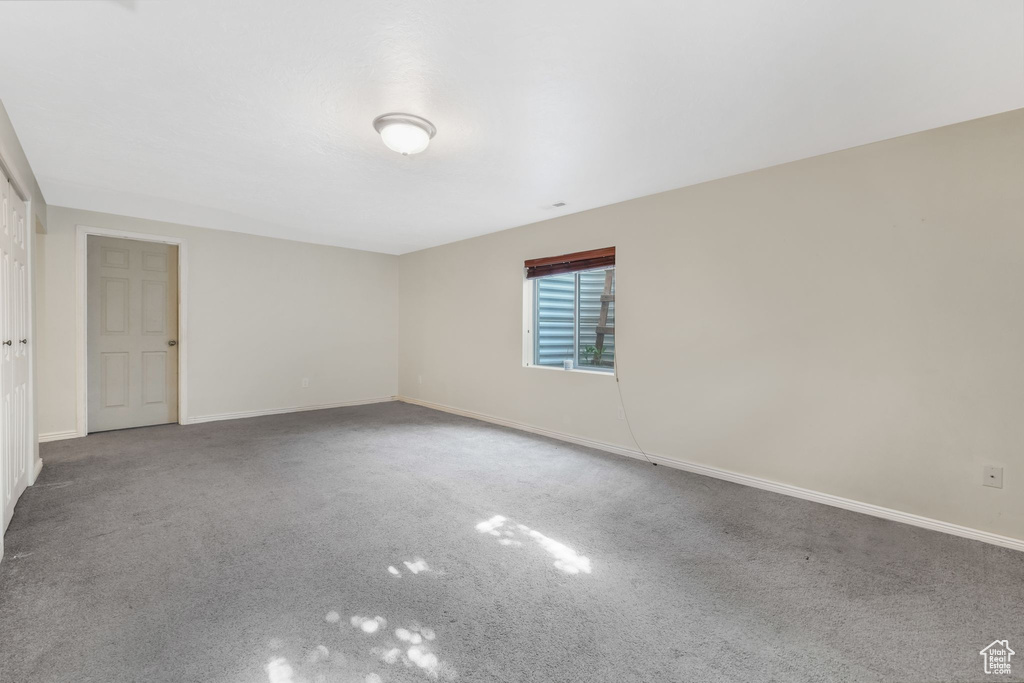 Unfurnished room with baseboards and carpet flooring