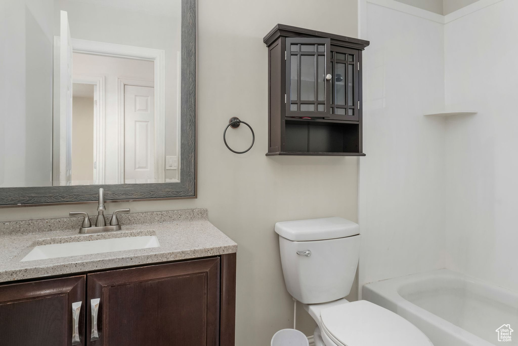 Full bath featuring vanity, toilet, and shower / tub combination