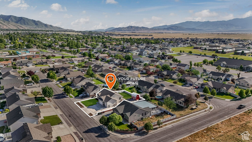 Aerial view of residential area featuring a mountainous background