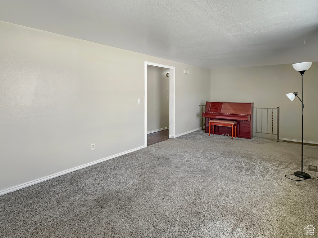 Carpeted living area with baseboards