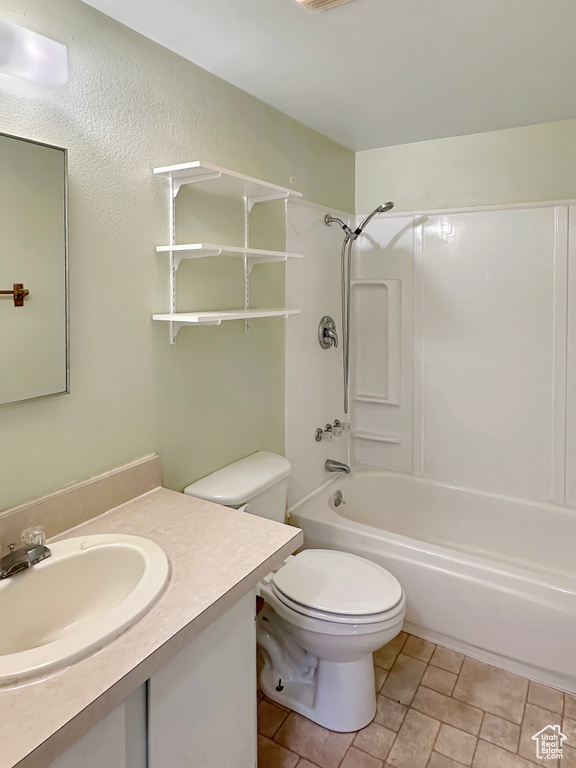 Bathroom with toilet, shower / tub combination, and vanity
