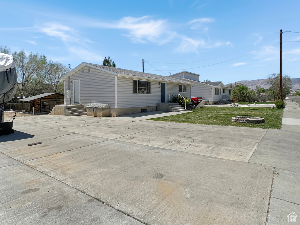 View of front of house featuring a front yard and entry steps
