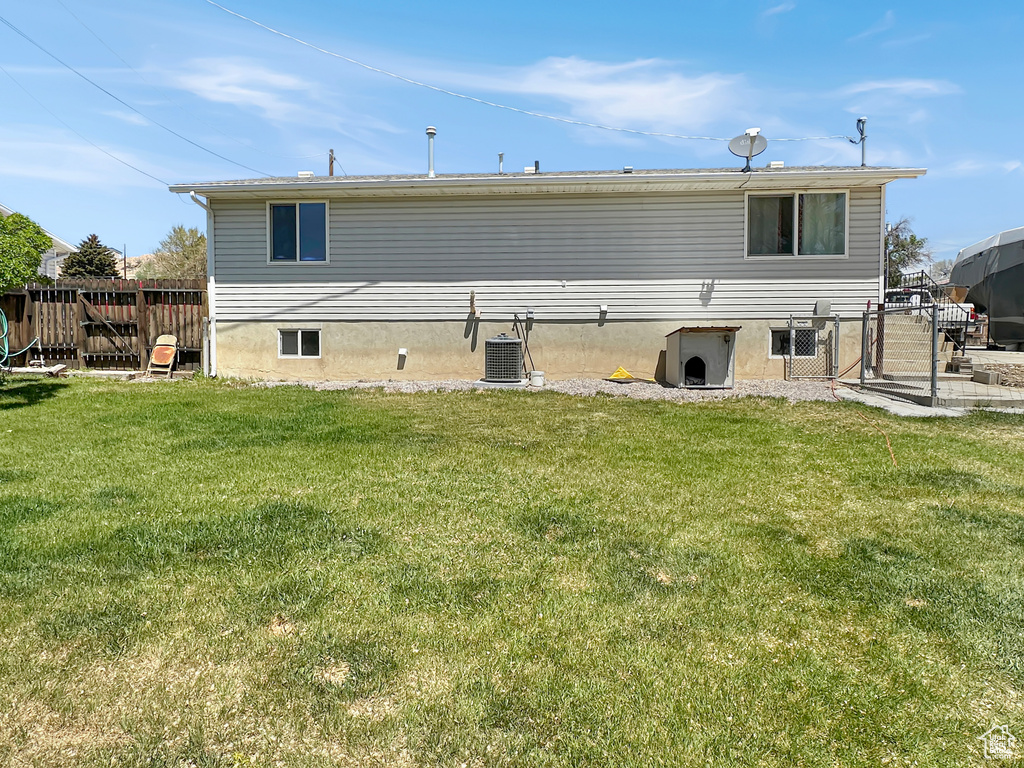 Back of house with central AC