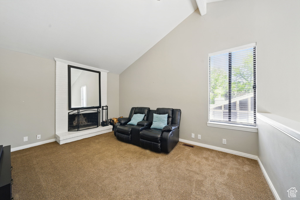 Living area with carpet floors, a fireplace, and baseboards