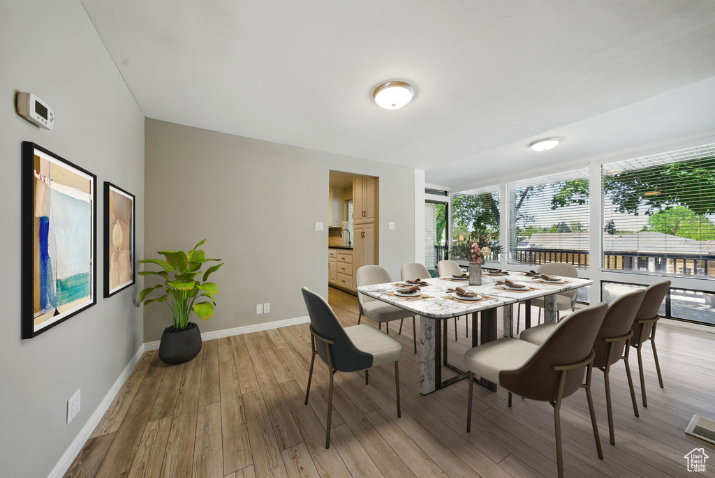 Dining room featuring light wood-type flooring and baseboards