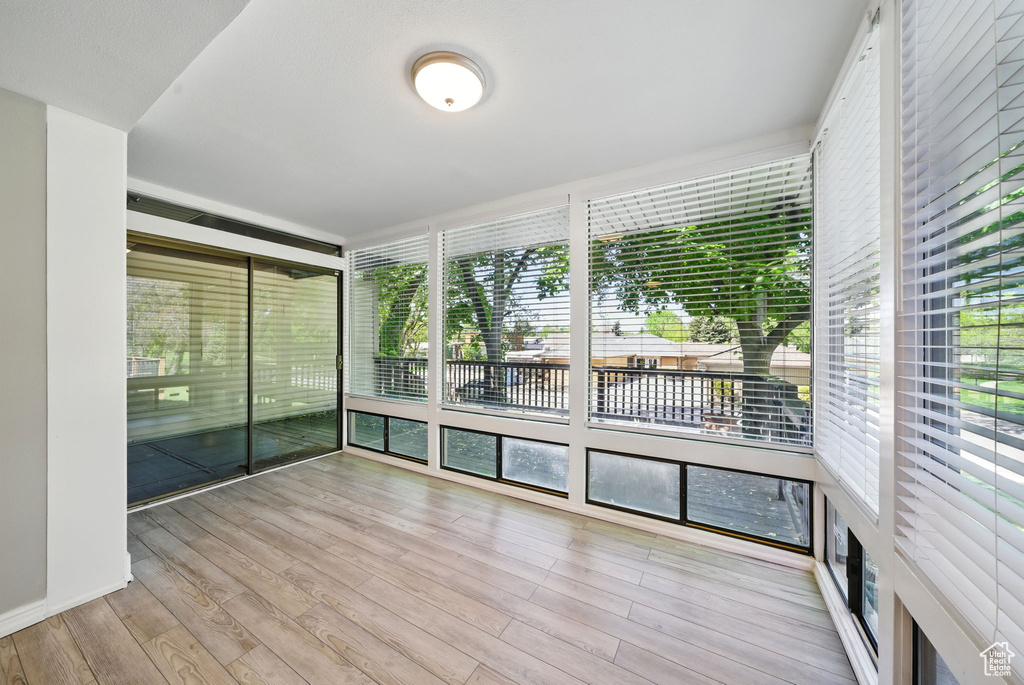 Unfurnished sunroom featuring wood finished floors