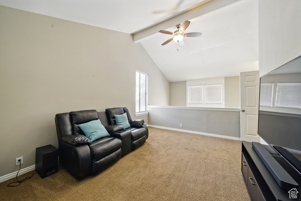 Living area with a ceiling fan, carpet flooring, and baseboards