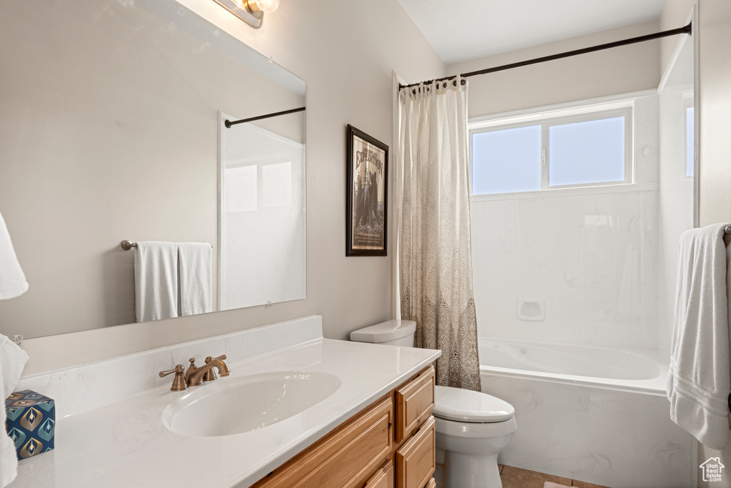 Full bathroom with vanity, toilet, and shower / tub combo with curtain