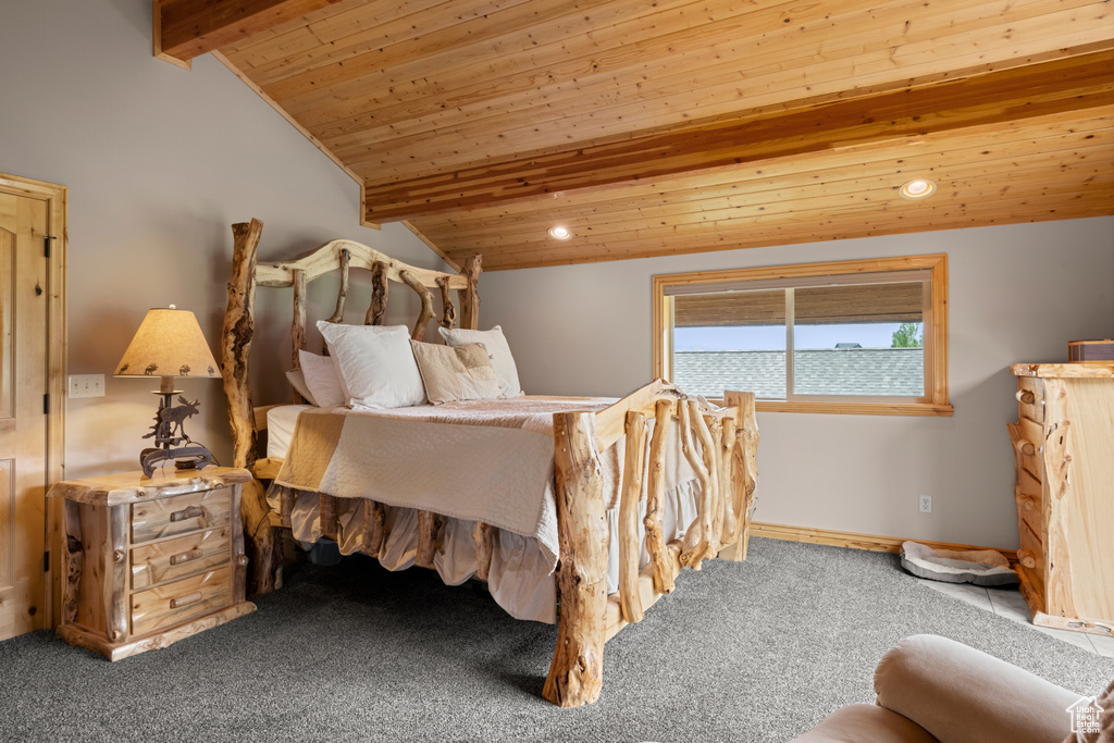 Bedroom featuring wooden ceiling, carpet floors, and baseboards