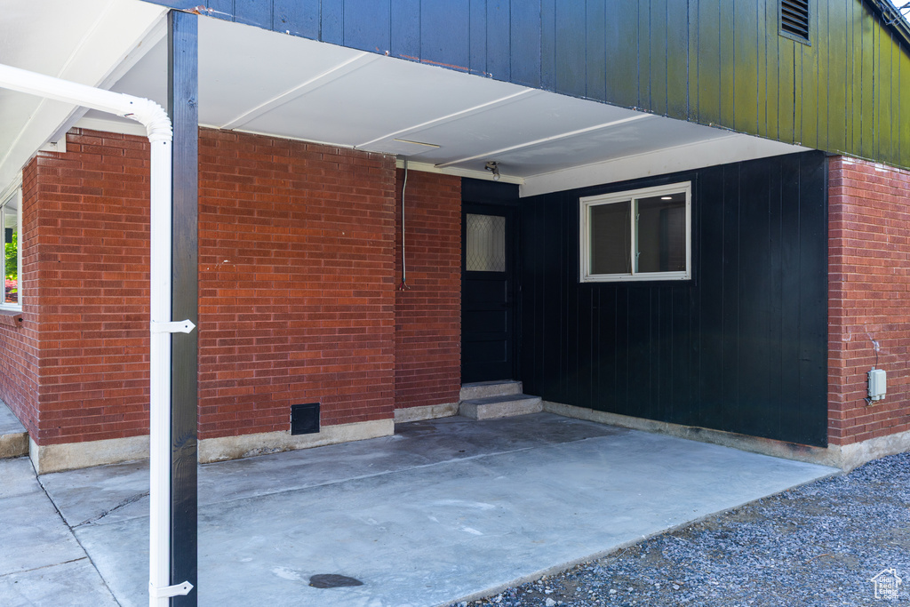 View of side of home featuring brick siding and entry steps