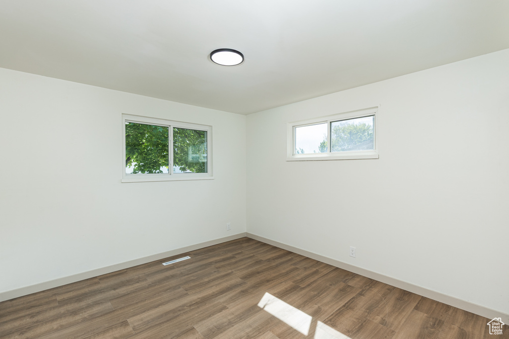 Unfurnished room featuring baseboards and wood finished floors