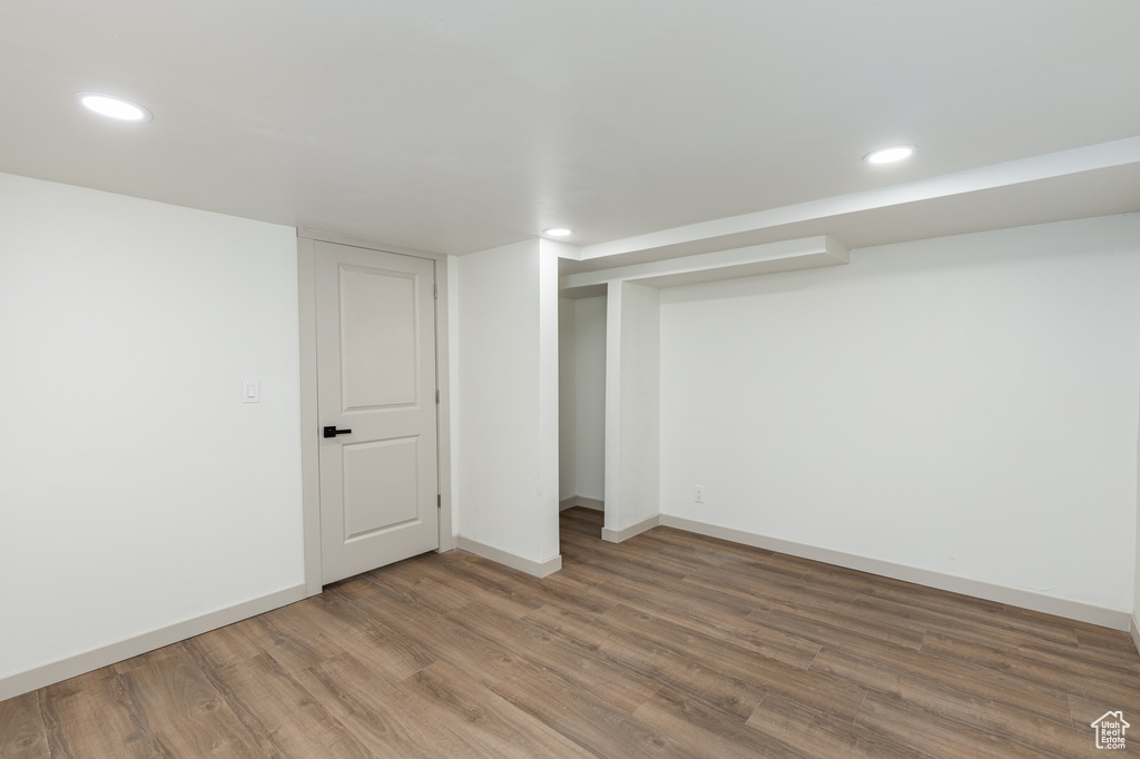 Finished below grade area with recessed lighting, wood finished floors, and baseboards