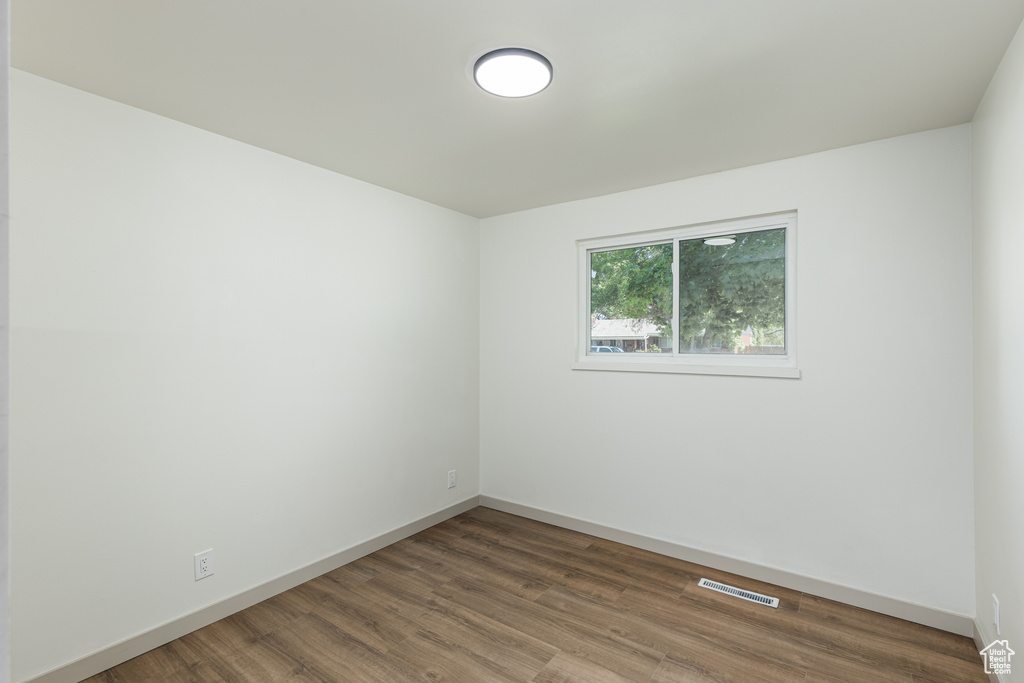 Spare room with wood finished floors and baseboards
