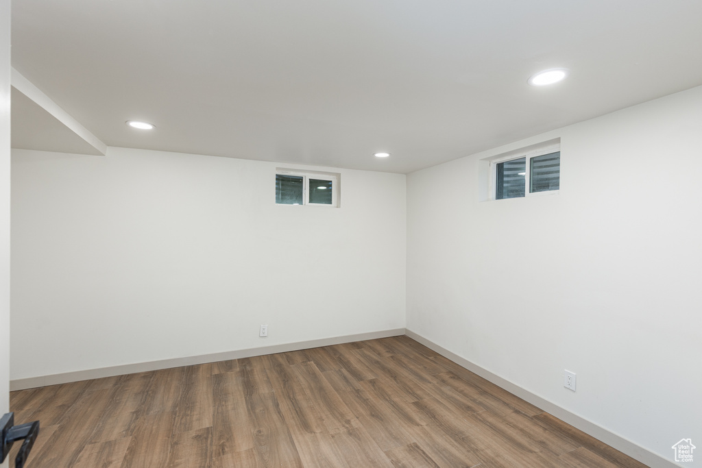Finished basement with wood finished floors, recessed lighting, and baseboards