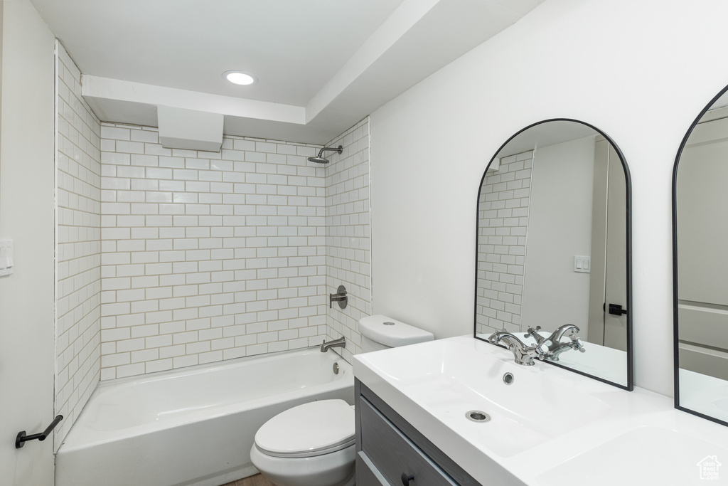 Full bath featuring toilet, shower / bath combination, vanity, and recessed lighting