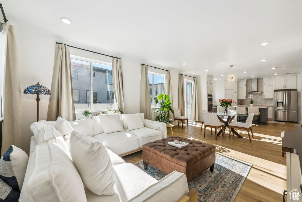 Living area featuring wood finished floors and recessed lighting