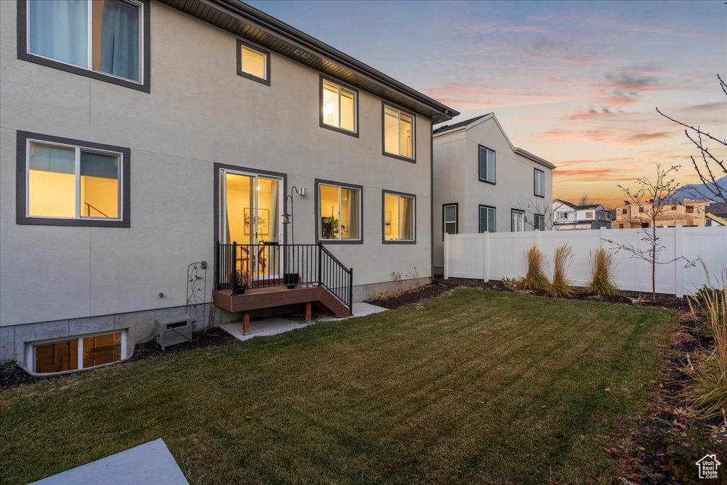 Back of property at dusk with stucco siding