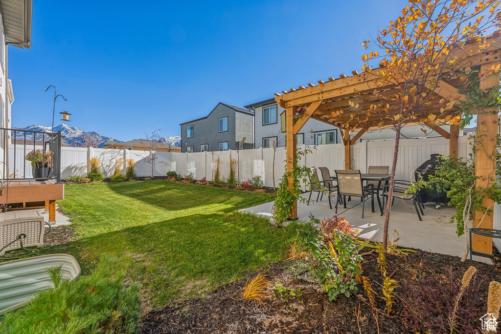 View of yard with a pergola, a patio area, and a mountain view