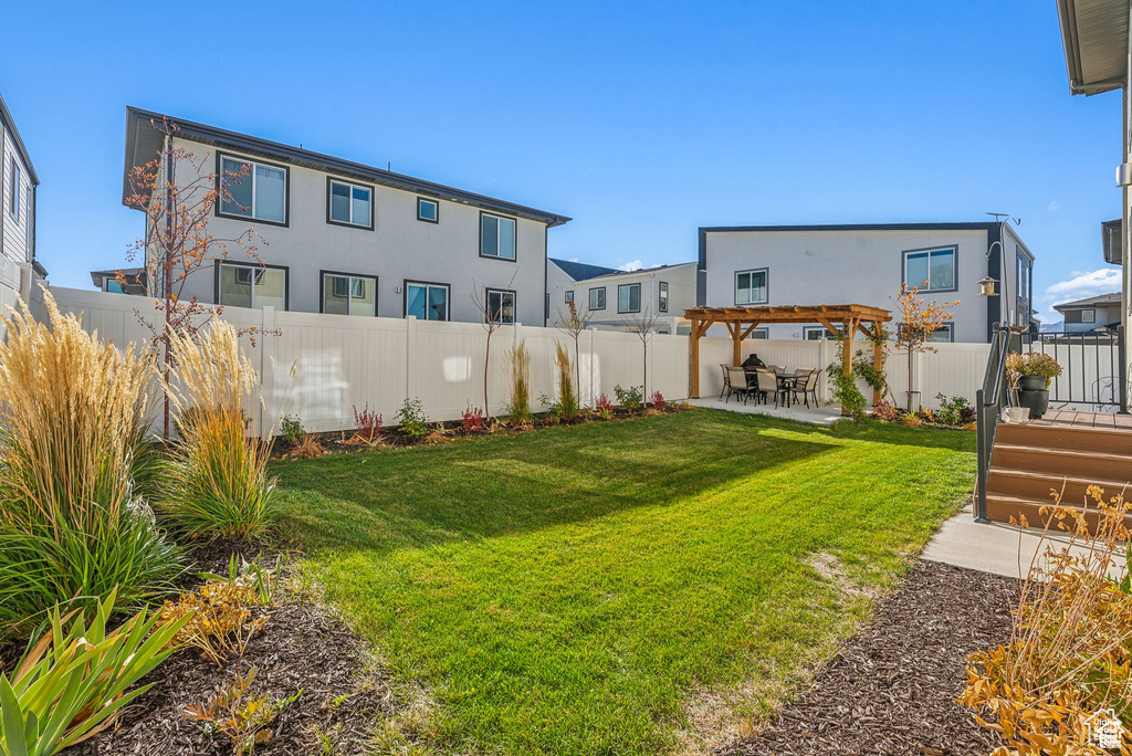 View of yard featuring a pergola and a patio area